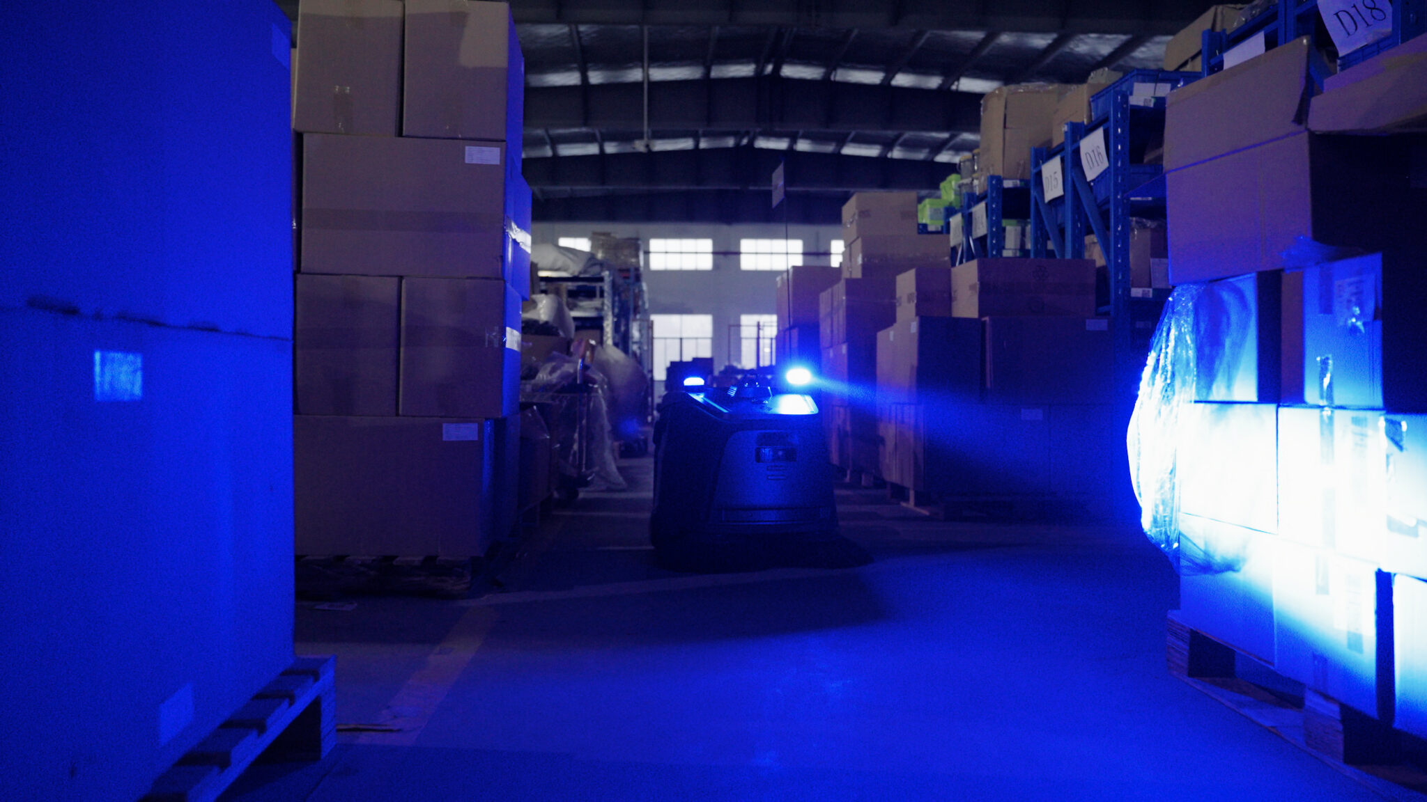 Beetle navigating a dark warehouse aisle using its headlight and sensors